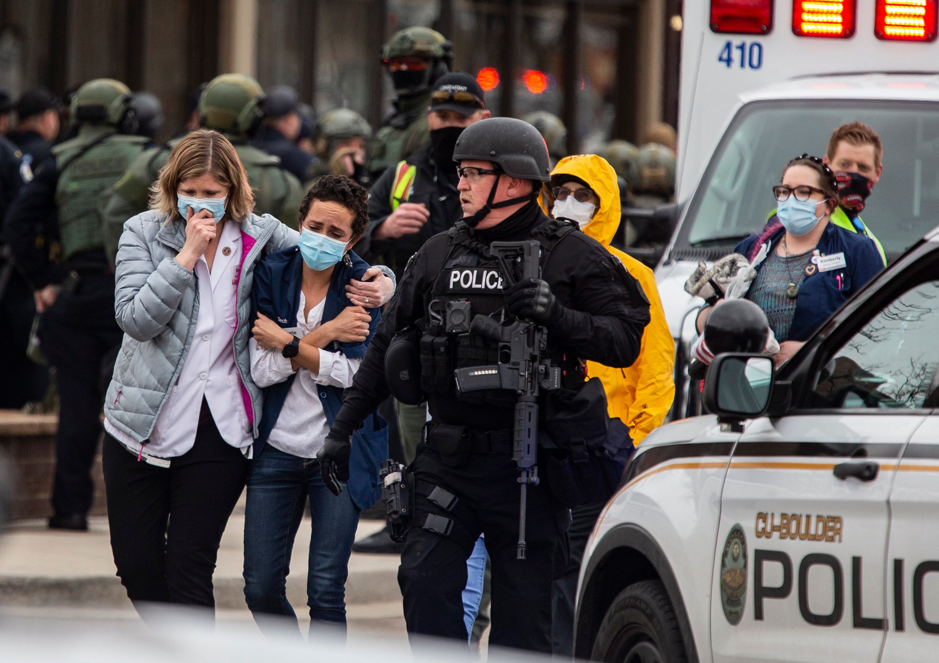 Healthcare workers walk out of a King Sooper&apos;s Grocery store after a gunman opened fire on March 22, 2021, in Boulder, Colorado. Dozens of police responded to the afternoon shooting in which at least one witness described three people who appeared to be wounded, according to published reports.  (Chet Strange/Getty Images/TNS)