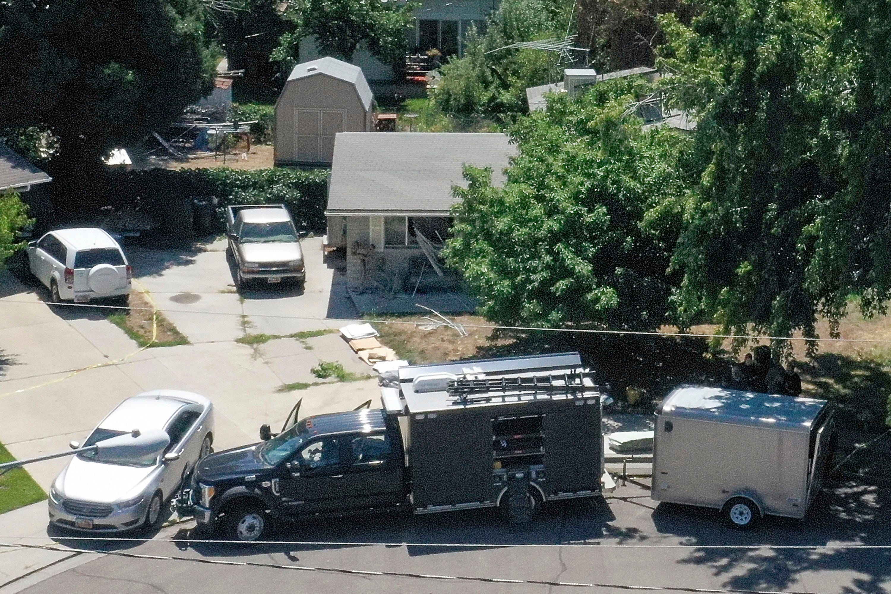 Law enforcement investigate the scene of a shooting involving the FBI in Provo, Utah, on Wednesday, Aug. 9, 2023. A Utah man accused of making violent threats against President Joe Biden was shot and killed by FBI agents hours before the president was expected to land in the state Wednesday, authorities say. The shooting happened around 6:15 a.m. as special agents tried to serve a warrant on the home of Craig Deleeuw Robertson in Provo,   south of Salt Lake City. (Laura Seitz/The Deseret News via AP) ORG XMIT: UTSAL105