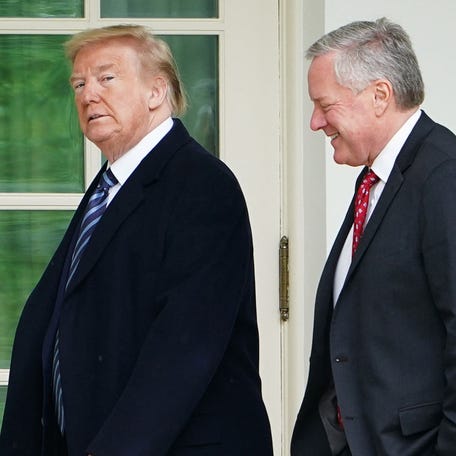 (FILES) US President Donald Trump walks with Chief of Staff Mark Meadows after returning to the White House from an event at the WWII memorial in Washington, DC, on May 8, 2020. Donald Trump was indicted August 14, 2023 on charges of racketeering and a string of election crimes after a sprawling two-year probe into his efforts to overturn his 2020 defeat to Joe Biden in the US state of Georgia, according to a court filing.    The indictment named a number of co-defendants including Trump's former personal lawyer Rudy Giuliani, who pressured local legislators over the result after the election, and Trump's White House chief of staff, Mark Meadows. (Photo by MANDEL NGAN / AFP) (Photo by MANDEL NGAN/AFP via Getty Images) ORIG FILE ID: AFP_33R467N.jpg