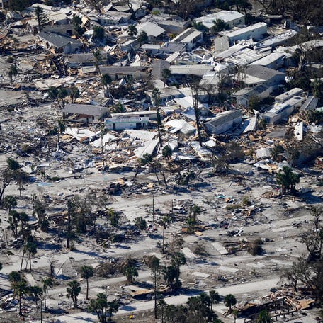 FILE - In this photo made in a flight provided by mediccorps.org, damage from Hurricane Ian is visible on Estero Island in Fort Myers Beach, Fla., Sept. 30, 2022.