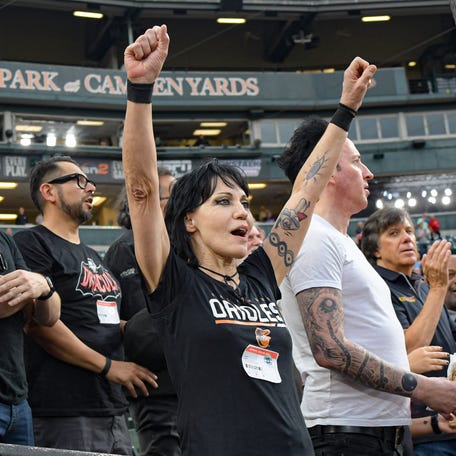 Aug 28, 2023; Baltimore, Maryland, USA;  Joan Jett, American singer, cheers before the start of the game between the Baltimore Orioles and the Chicago White Sox at Oriole Park at Camden Yards.