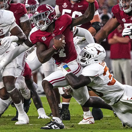 Alabama quarterback Jalen Milroe (4) is sacked by Texas linebacker David Gbenda (3) during the game at Bryant-Denny Stadium on Saturday, Sep. 9, 2023 in Tuscaloosa,