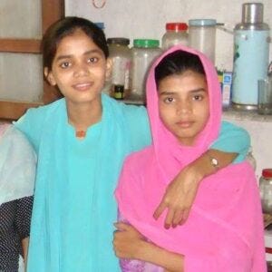 Nasreen Sheikh, in blue, worked in illegal sweatshops in the inner-city slums of Kathmandu, Nepal, and grew up in forced labor.