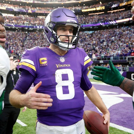 Minnesota Vikings quarterback Kirk Cousins (8) talks with New York Jets players after an NFL football game, Sunday, Dec. 4, 2022, in Minneapolis.