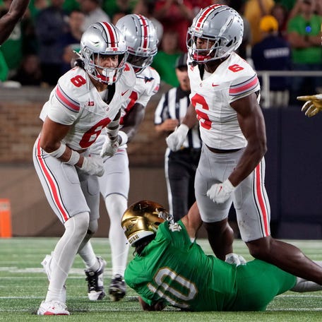 Ohio State safety Lathan Ransom (8) stops Notre Dame quarterback Sam Hartman (10) on fourth down during the third quarter of their game at Notre Dame Stadium.