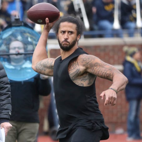 Jim Harbaugh watches former 49ers quarterback Colin Kaepernick throw passes at halftime of the Michigan spring game April 2, 2022 at Michigan Stadium in Ann Arbor.    Mich Spring