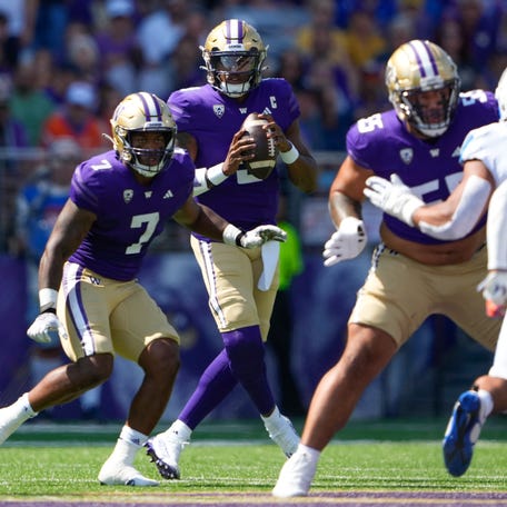 Washington quarterback Michael Penix Jr. holds the ball as he looks for a pass opening against Boise State during the first half at Husky Stadium in Seattle.
