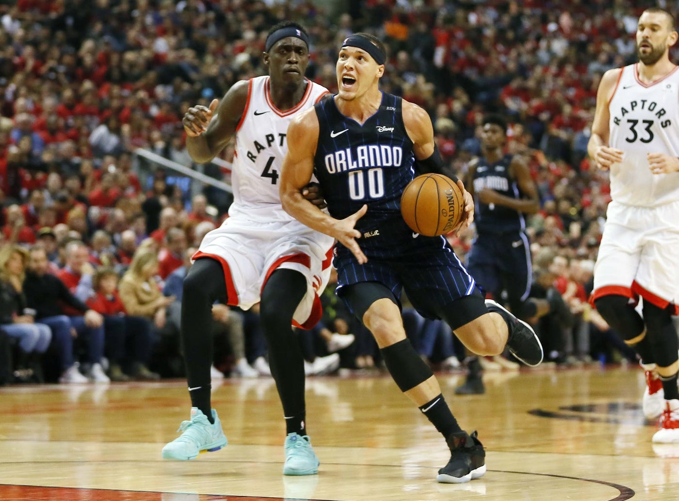 Apr 13, 2019; Toronto, Ontario, CAN; Orlando Magic forward Aaron Gordon (00) drives to the net against Toronto Raptors forward Pascal Siakam (43) during the first half of game one of the first round of the 2019 NBA Playoffs at Scotiabank Arena.