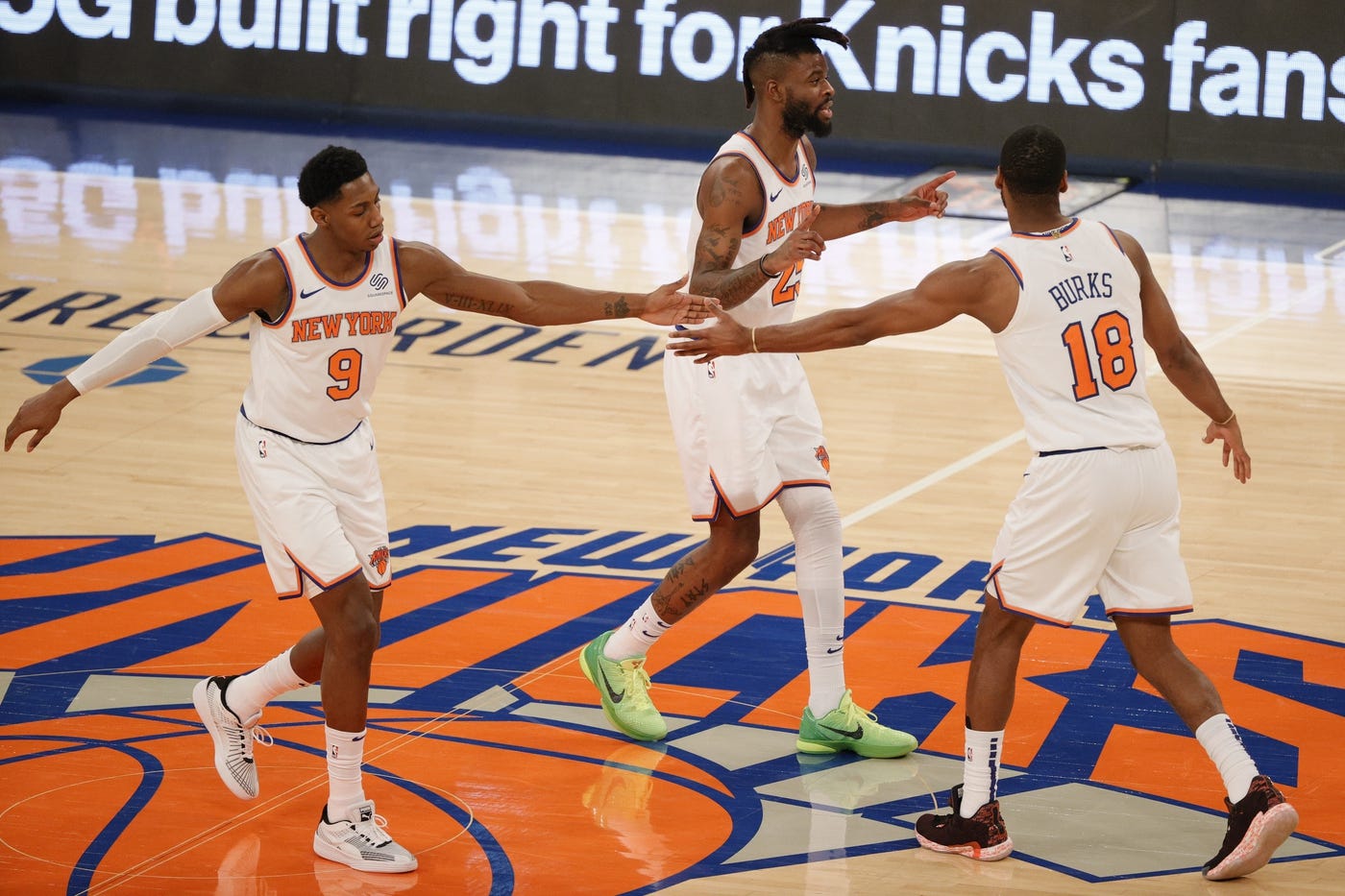 Feb 21, 2021; New York, New York, USA; RJ Barrett #9, Reggie Bullock #25, and Alec Burks #18 of the New York Knicks high-five during the second half against the Minnesota Timberwolves at Madison Square Garden on February 21, 2021 in New York City. The Knicks won 103-99.
