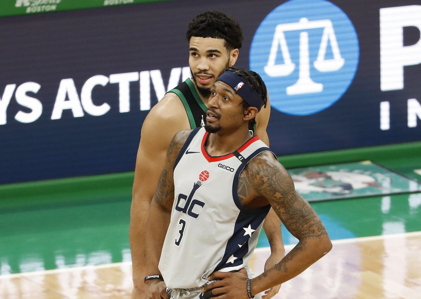 Feb 28, 2021; Boston, Massachusetts, USA; Boston Celtics forward Jayson Tatum (0) talks with Washington Wizards guard Bradley Beal (3) during the second quarter at TD Garden.
