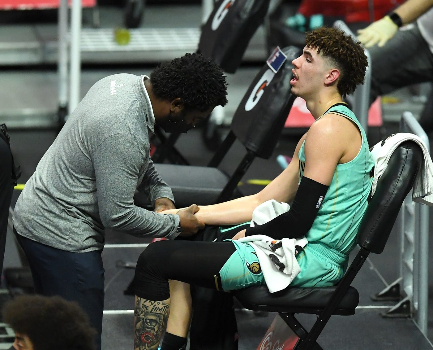 Mar 20, 2021; Los Angeles, California, USA; Charlotte Hornets team trainer checks the wrist of guard LaMelo Ball (2) in the second half of the game against the Los Angeles Clippers at Staples Center. 