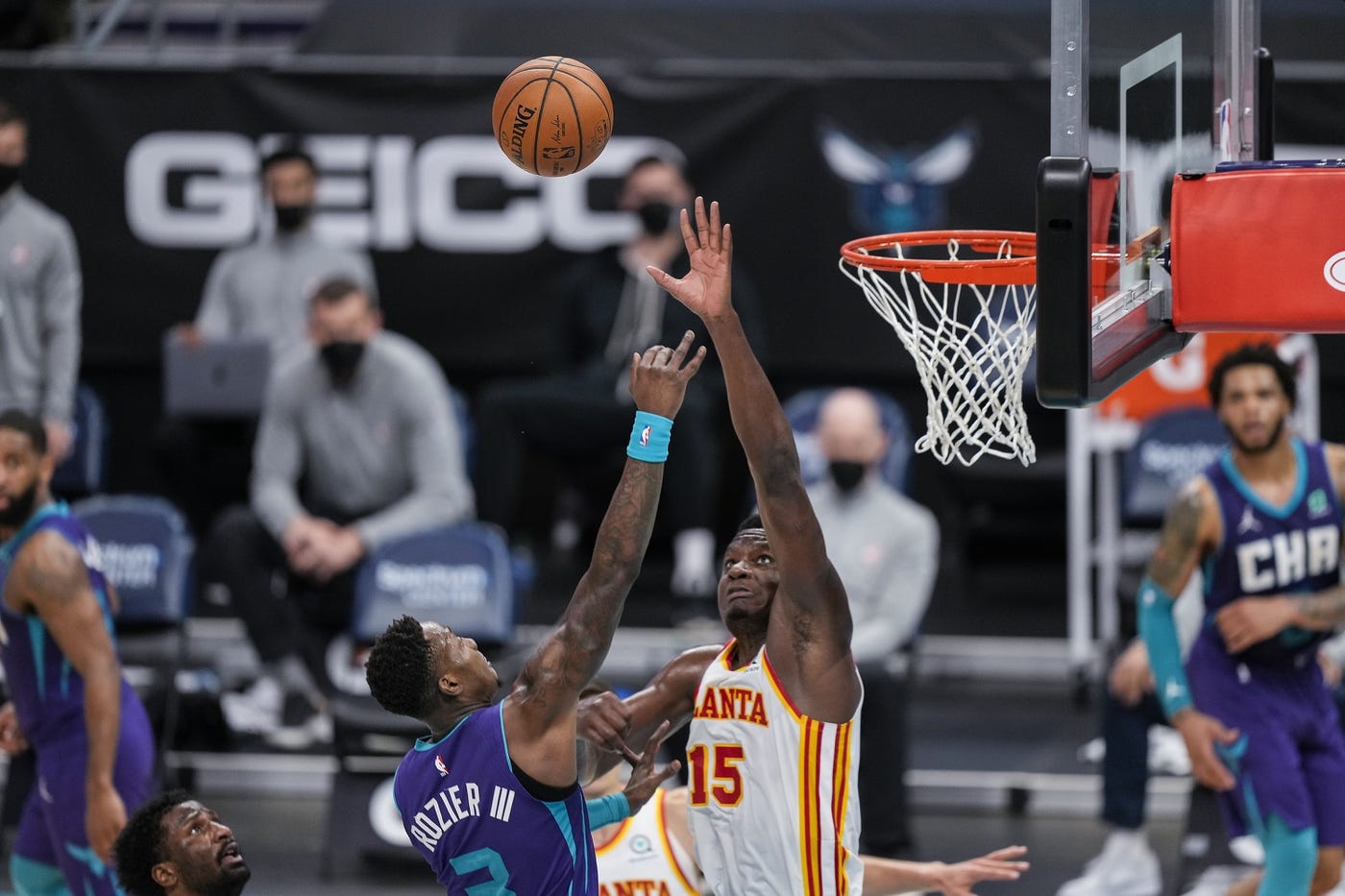 Apr 11, 2021; Charlotte, North Carolina, USA; Atlanta Hawks center Clint Capela (15) tries to block a shot by Charlotte Hornets guard Terry Rozier (3) during the second half at Spectrum Center. Mandatory Credit: Jim Dedmon-USA TODAY Sports