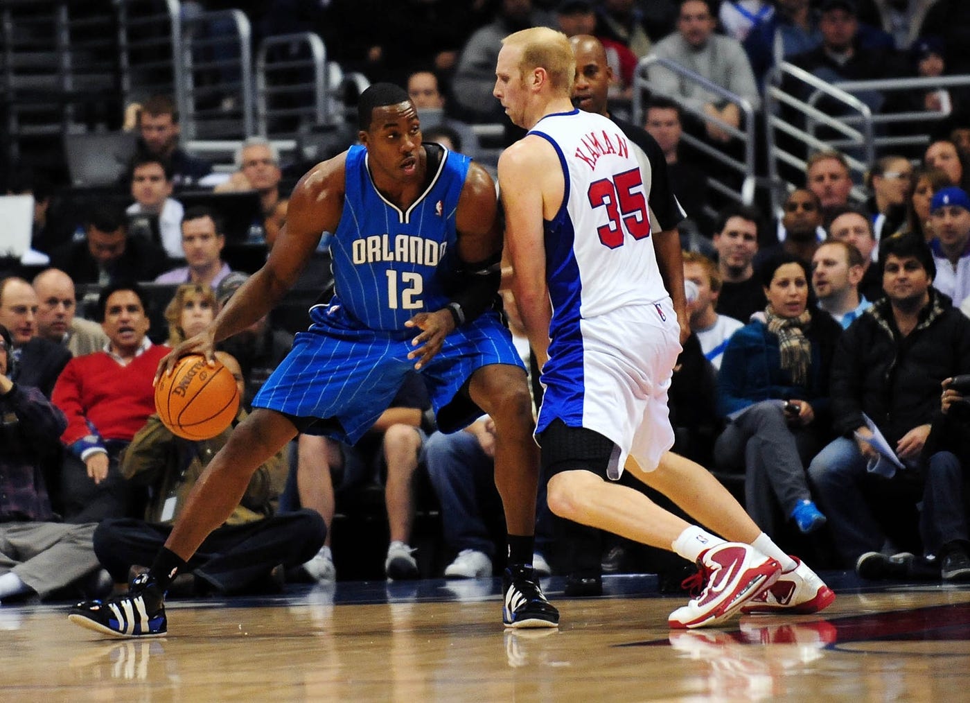 December 8, 2009; Los Angeles, CA, USA; Orlando Magic center Dwight Howard (12) moves the ball against the defense of Los Angeles Clippers center Chris Kaman (35) during the second half at the Staples Center. Orlando defeats Los Angeles 97-86.
