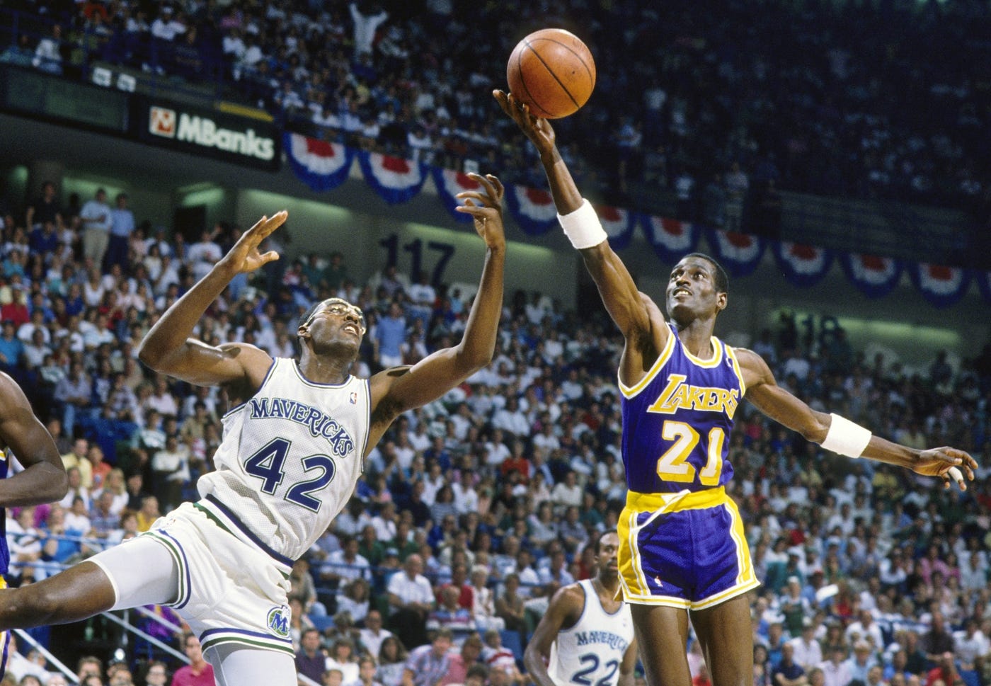 May 1988; Dallas, TX, USA; FILE PHOTO; Los Angeles Lakers forward Michael Cooper (21) shoots over Dallas Mavericks forward Roy Tarpley (42) during the 1988 NBA Western Conference Finals at Reunion Arena. Mandatory Credit: MPS-USA TODAY Sports