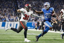Jan 21, 2024; Detroit, Michigan, USA; Detroit Lions running back Jahmyr Gibbs (26) runs for a touchdown against Tampa Bay Buccaneers safety Antoine Winfield Jr. (31) during the second half in a 2024 NFC divisional round game at Ford Field. Mandatory Credit: Junfu Han-USA TODAY Sports