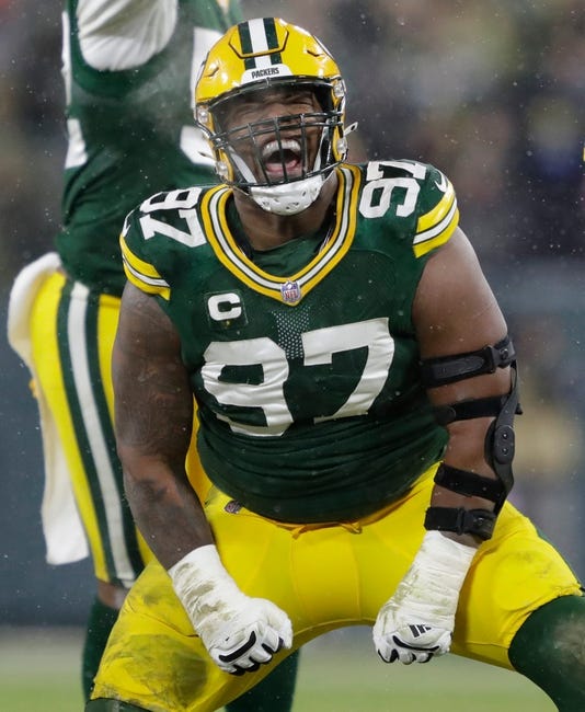 Syndication: The Post-Crescent - Green Bay Packers nose tackle Kenny Clark (97) celebrates after sacking San Francisco 49ers quarterback Jimmy Garoppolo (10) in the third quarter during their NFL divisional round football playoff game Saturday Jan. 22, 2022, at Lambeau Field in Green Bay.Apc Packvs49ers 0122221366djp