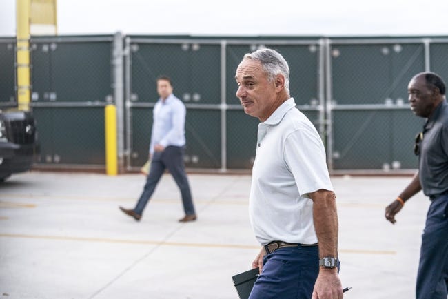 MLB: Lockout - Feb 28, 2022; Jupiter, FL, USA; Major League Baseball Commissioner Rob Manfred, center, walks after negotiations with the players association in an attempt to reach an agreement to salvage March 31 openers and a 162-game season, Monday, Feb. 28, 2022, at Roger Dean Stadium in Jupiter, Fla. Mandatory Credit: Greg Lovett-USA TODAY NETWORK