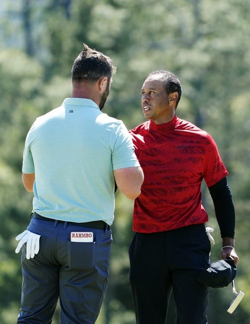 Golf: Masters Tournament - Final Round - Apr 10, 2022; Augusta, Georgia, USA; Tiger Woods shakes hands with Jon Rahm after finishing on no. 18 during the final round of the Masters Tournament at Augusta National Golf Club. Mandatory Credit: Danielle Parhizkaran-Augusta Chronicle/USA TODAY Sports