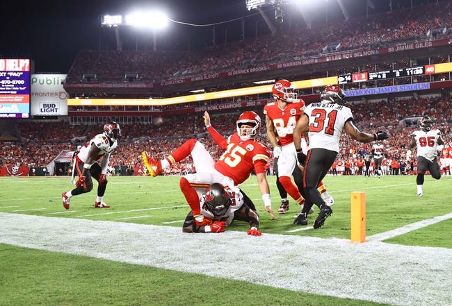 NFL: Kansas City Chiefs at Tampa Bay Buccaneers - Oct 2, 2022; Tampa, Florida, USA; Kansas City Chiefs quarterback Patrick Mahomes (15) gets tripped up by Tampa Bay Buccaneers safety Keanu Neal (22) after he throws the ball in for a touchdown during the first half at Raymond James Stadium. Mandatory Credit: Kim Klement-USA TODAY Sports