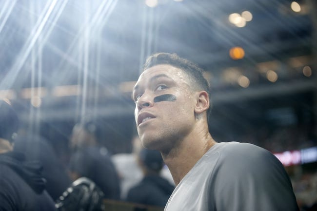 MLB: Game Two-New York Yankees at Texas Rangers - Oct 4, 2022; Arlington, Texas, USA; New York Yankees right fielder Aaron Judge (99) smiles in the dugout after hitting home run #62 to break the American League home run record in the first inning against the Texas Rangers at Globe Life Field. Mandatory Credit: Tim Heitman-USA TODAY Sports
